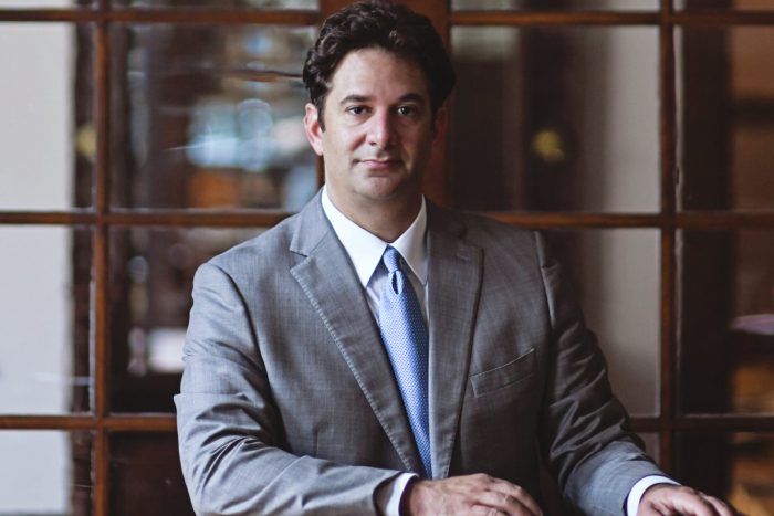 R. Reagan Sahadi, personal injury attorney, in a formal office setting