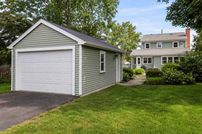 A standalone detached garage beside a suburban home