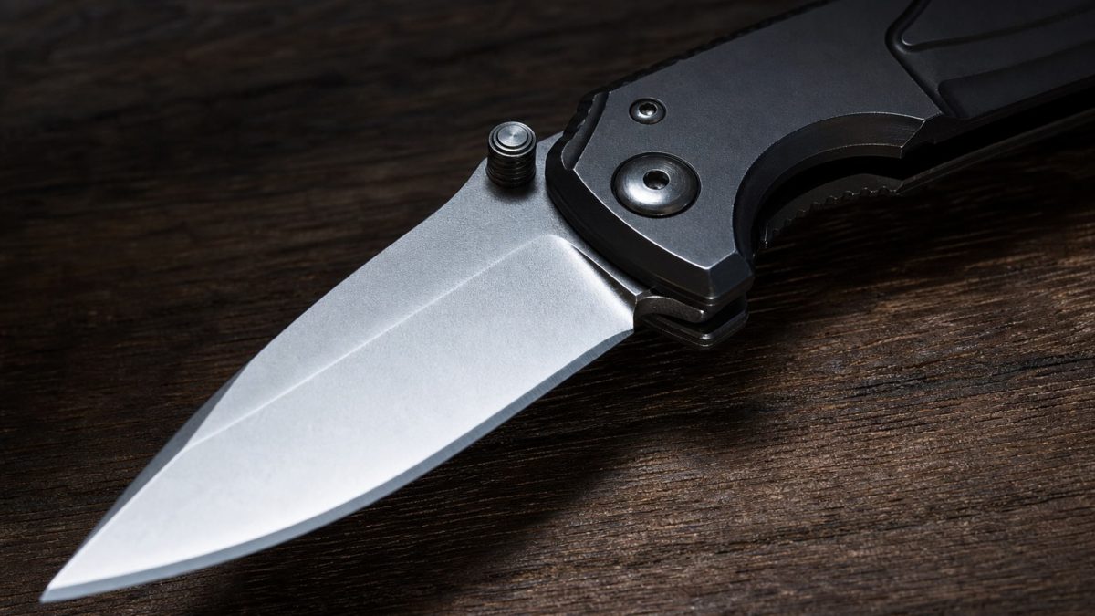 Spring-assisted folding pocket knife with blade partially open