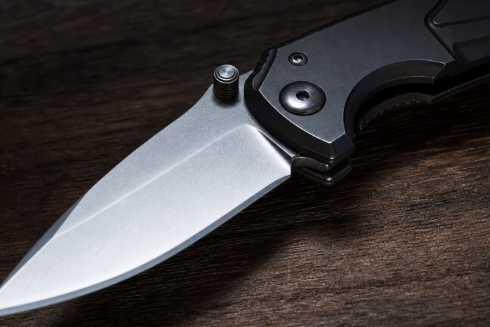 Spring-assisted folding pocket knife with blade partially open